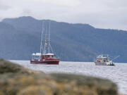 FILE - Two commercial troll fishing boats pass each other on June 2, 2020, at Mountain Point in Ketchikan, Alaska. A U.S. appeals court on Wednesday, June 21, 2023, halted a lower court ruling that would have shut down southeast Alaska's chinook salmon fishery for the summer to protect endangered orca whales that eat the fish.