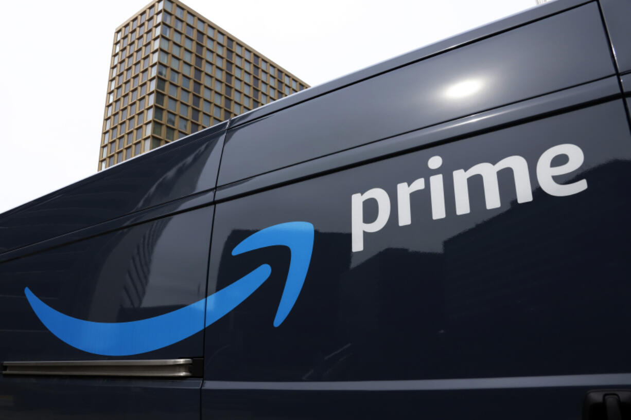 FILE - An Amazon Prime delivery vehicle is seen in downtown Pittsburgh on March 18, 2020. The Federal Trade Commission sued Amazon on Wednesday for what it called a years-long effort to enroll consumers without consent into its Prime program and making it difficult for them to cancel their subscriptions. (AP Photo/Gene J.