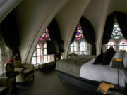 Sunlight filters in through stained glass windows in a guest room June 19 at the Martin's Patershof hotel in the center of Mechelen, Belgium.