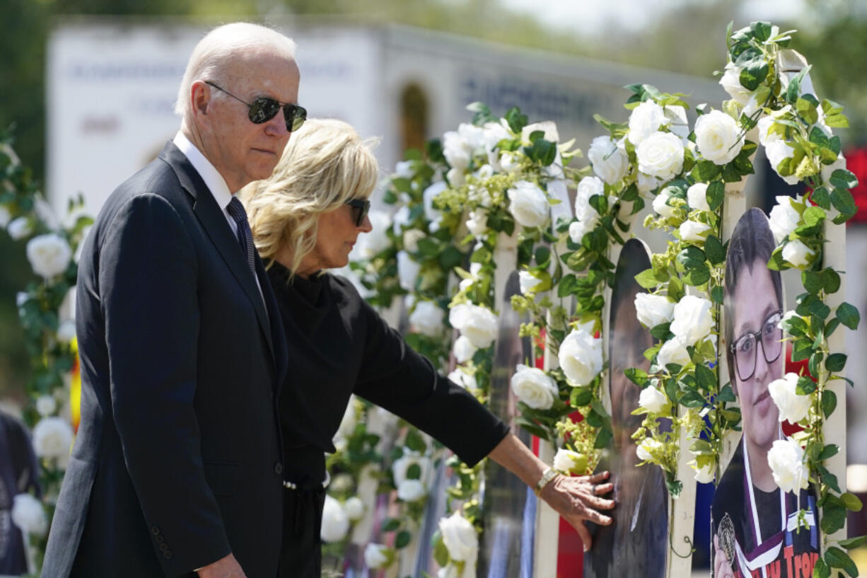 FILE - President Joe Biden and first lady Jill Biden visit a memorial at Robb Elementary School to pay their respects to the victims of the mass shooting, May 29, 2022, in Uvalde, Texas. Biden will speak at a summit in Connecticut on Friday, June 16, 2023, to mark the first anniversary of a gun safety law signed after the school massacre in Uvalde, Texas.