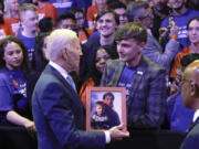 President Joe Biden speaks with people in the audience after delivering a speech at the National Safer Communities Summit at the University of Hartford in West Hartford, Conn., Friday, June 16, 2023. The summit is attended by gun safety advocates, local leaders and families impacted by gun violence.