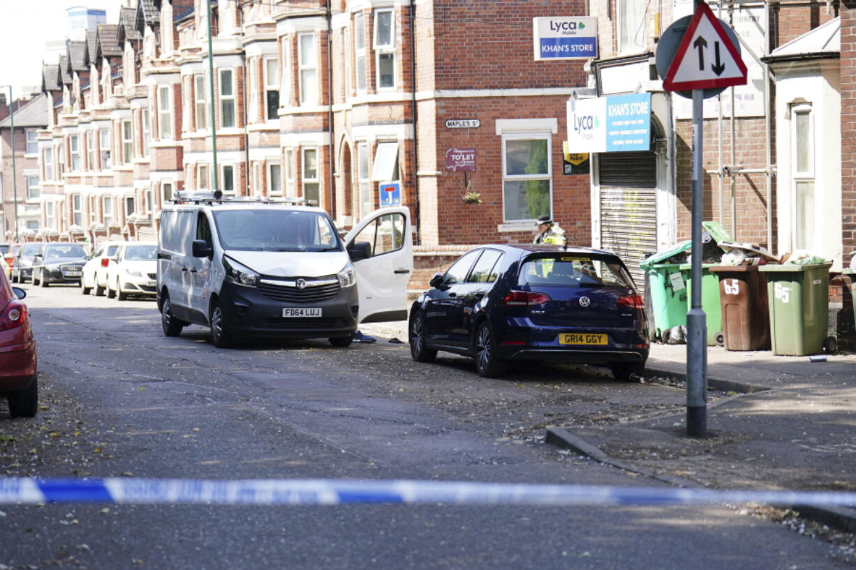 A white van is seen behind a police cordon on the corner of Maples Street and Bentinck Road  on the corner of Maples Street and Bentinck Road after three people were killed in Nottingham city center, England early on Tuesday, June 13, 2023. A man was arrested on suspicion of murder in the English city of Nottingham Tuesday after three people were found dead and three others were hit and injured by a van in related early-morning incidents, police said.