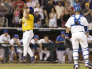 LSU's Cade Veloso (24) celebrates as he approaches home plate after hitting a solo home run to take the lead against Florida in the 11th inning of Game 1 of the NCAA College World Series baseball finals in Omaha, Neb., Saturday, June 24, 2023. (AP Photo/Rebecca S.