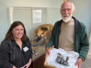 Santa Cruz Museum of Natural History Visitor Experience Manager Liz Broughton, left, and Jim Smith, who holds a mastodon tooth May 30 at the museum in Santa Cruz, Calif. Smith, who had seen the news about the tooth, called the museum and reported he had stumbled upon it at the mouth of Aptos Creek on Rio Del Mar State Beach, located off Monterey Bay in Santa Cruz County.