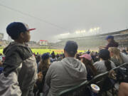 Fans watch a baseball game between the Philadelphia Phillies and Chicago Cubs as smoke from Canada's ongoing wildfires shrouds Wrigley Field in a haze, in Chicago, Tuesday, June 27, 2023.