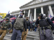 FILE - Members of the Oath Keepers extremist group stand on the East Front of the U.S. Capitol on Jan. 6, 2021, in Washington. David Moerschel, a 45-year-old neurophysiologist from Punta Gorda, Fla., who stormed the U.S. Capitol with other members of the far-right Oath Keepers group, was sentenced Friday to three years in prison for seditious conspiracy and other charges, the latest in a historic string of sentences in the Jan. 6. 2021 attack.