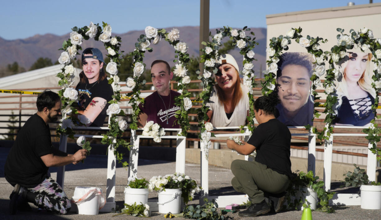 FILE - Noah Reich, left, and David Maldonado, the Los Angeles co-founders of Classroom of Compassion, set up a memorial near Club Q in Colorado Springs, Colo., on Nov. 22, 2022, with photographs of the five victims of a mass shooting at the gay nightclub.