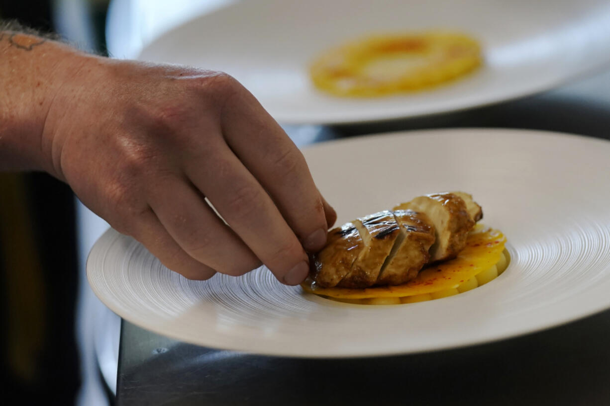 Chef Zach Tyndall prepares Good Meat's cultivated chicken Wednesday at the Eat Just office in Alameda, Calif.