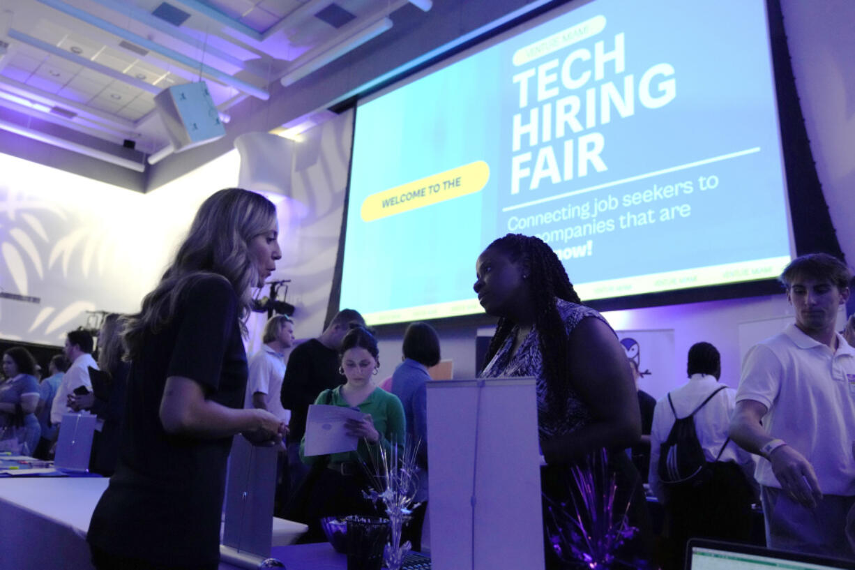 File - Visitors attend the Venture Miami Tech Hiring Fair at the Miami-Dade College, Wolfson campus, Wednesday, April 26, 2023, in Miami. On Friday, the U.S. government issues the May jobs report. The labor market has added jobs at a steady clip in the past year, despite efforts by the Federal Reserve to cool the economy and bring down inflation.