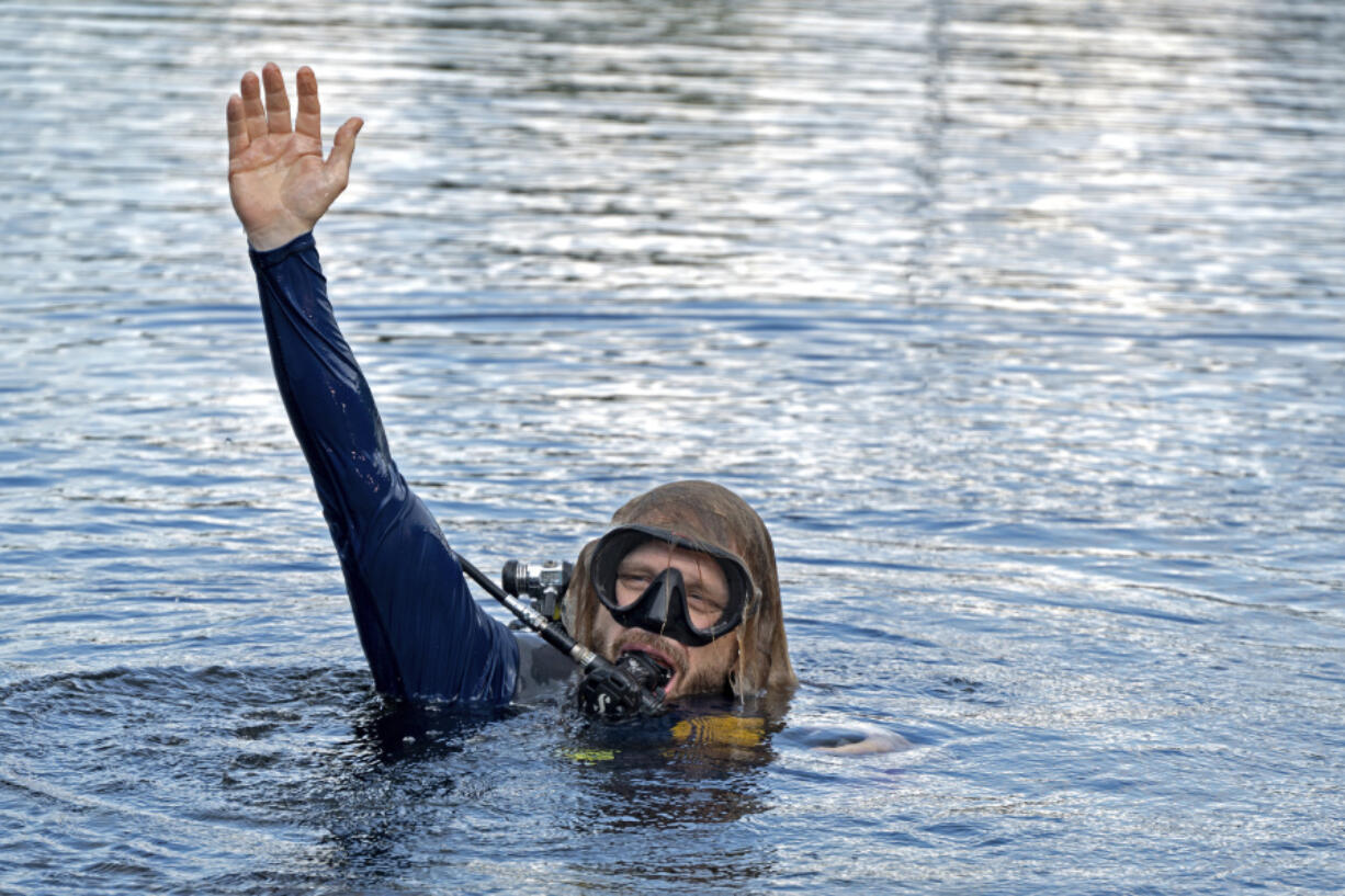 In this photo provided by the Florida Keys News Bureau, diving explorer and medical researcher Dr. Joseph Dituri surfaces Friday, June 9, 2023, after living for 100 days in the Jules' Undersea Lodge marine habitat at the bottom of a lagoon in Key Largo, Fla. Dituri broke the previous 73-day record for underwater human habitation at ambient pressure, undertook medical and marine science research and interacted online with more than 5,500 students during his Project Neptune 100 mission organized by the Marine Resources Development Foundation.