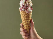 This image provided by Salt & Straw shows a cone filled with one of the company's most unique offerings - a Thanksgiving feast in ice cream form, with turkey bacon, buttery brittle and jammy cranberry sauce flavors folded into a creamy base.