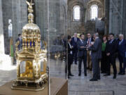 France's President Emmanuel Macron, center, visits a exhibition tracing the site's encyclopedic history via 30 objects in Le Mont-Saint-Michel, north-western France, Monday, June 5, 2023. France's mystical sea-surrounded abbey at Mont-Saint-Michel, a major tourist draw and UNESCO heritage site, celebrates its 1000th birthday.