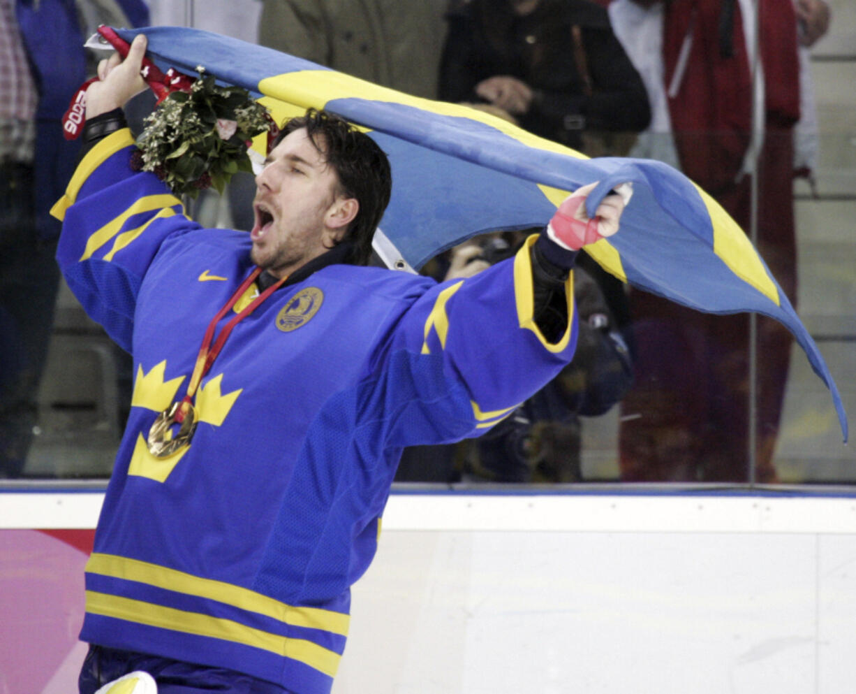 FILE - Sweden's goalie Henrik Lundqvist celebrates after beating Finland 3-2 to win the gold medal in the 2006 Winter Olympics men's ice hockey gold medal game in Turin, Italy, Feb. 26, 2006. Henrik Lundqvist is expected to be elected to the Hockey Hall of Fame in his first year of eligibility.  (AP Photo/Gene J.