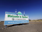 FILE - A sign at the Hanford Nuclear Reservation is posted near Richland, Wash., on Aug. 14, 2019. Three tribes have devoted decades to returning their ancestral lands in Washington to the days before they became the most radioactively contaminated site in the nation's nuclear weapons complex.  But the Yakama Nation, Confederated Tribes of the Umatilla Indian Reservation and Nez Perce Tribe have been left out of negotiations on a major decision affecting the future cleanup of millions of gallons of radioactive waste stored in underground tanks on the reservation.