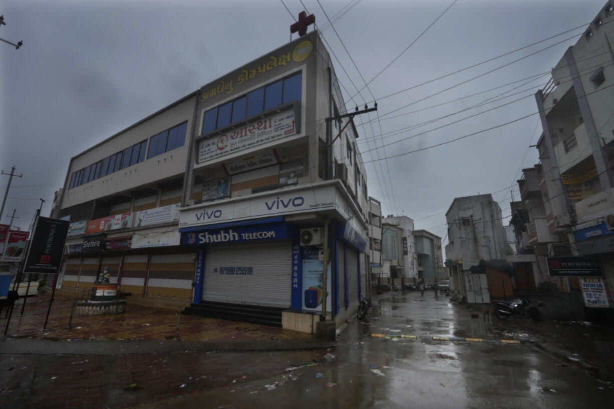 A market remains closed following instructions from authorities ahead of cyclone Biparjoy's landfall at Mandvi in Kutch district of Gujarat state, India, Thursday, June 15, 2023. A vast swath of western India and neighboring southern Pakistan that suffered deadly floods last year are bracing for a new deluge as fast-approaching Cyclone Biparjoy whirls toward landfall Thursday.