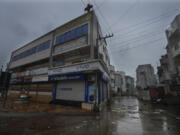 A market remains closed following instructions from authorities ahead of cyclone Biparjoy's landfall at Mandvi in Kutch district of Gujarat state, India, Thursday, June 15, 2023. A vast swath of western India and neighboring southern Pakistan that suffered deadly floods last year are bracing for a new deluge as fast-approaching Cyclone Biparjoy whirls toward landfall Thursday.