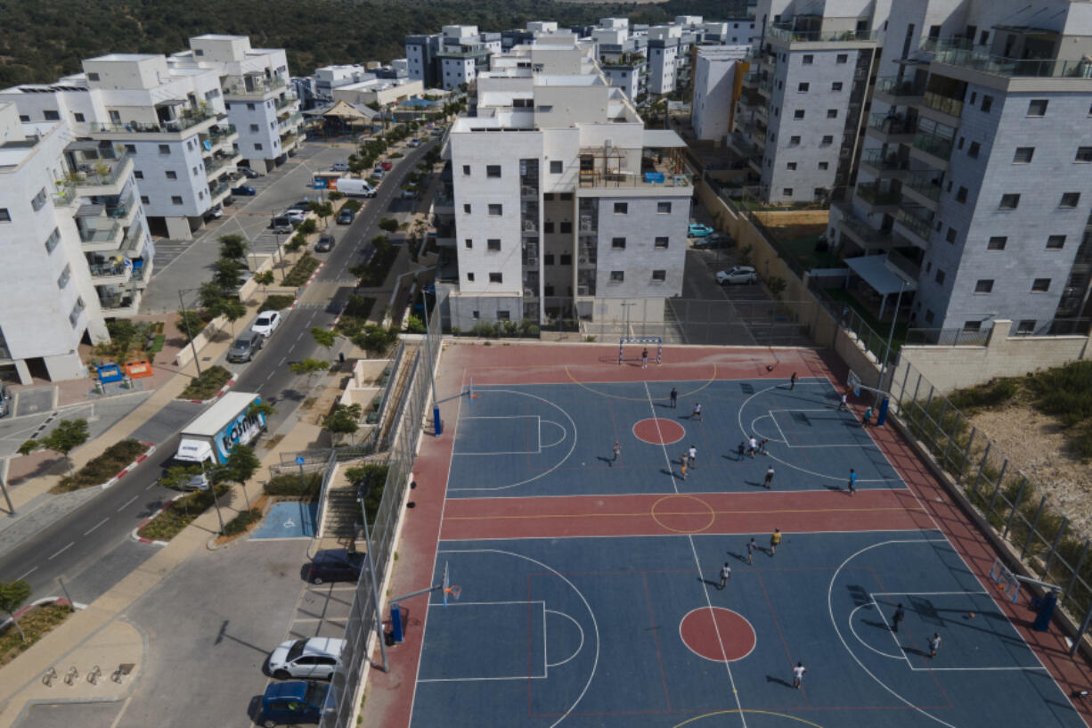 Boys play in a school yard in Harish, a city with a mixed population where secular and ultra-Orthodox Jews recently scuffled at a children's indoor playground that opened for business on the Jewish sabbath, Wednesday, June 7, 2023. With ultra-Orthodox parties now wielding unprecedented power and playing a key role in a contentious plan to overhaul the legal system, they are aggravating concerns among secular Israelis that the character and future of their country is under threat.