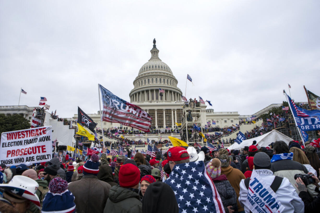 FILE - Rioters loyal to President Donald Trump rally at the U.S. Capitol in Washington on Jan. 6, 2021. Law enforcement officials say, Taylor Taranto, a man wanted for crimes related to the Jan. 6, 2021, insurrection at the U.S. Capitol has been arrested in the Washington neighborhood where former President Barack Obama lives. Taranto was seen a few blocks from the former president's home, and he fled even though he was chased by U.S. Secret Service agents.