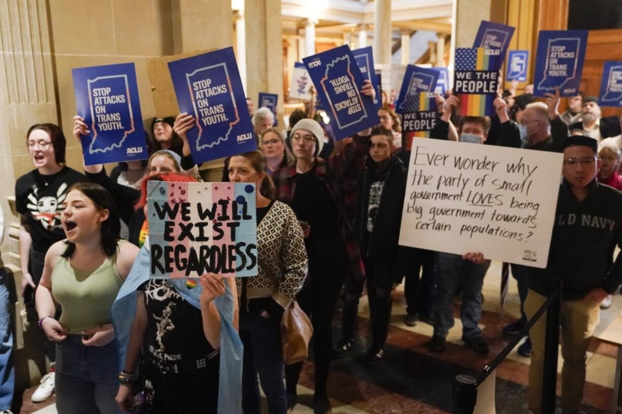 FILE - Protesters stand outside of the Senate chamber at the Indiana Statehouse on Feb. 22, 2023, in Indianapolis. The Human Rights Campaign declared a state of emergency for LGBTQ+ people in the U.S. on Tuesday, June 6 and a released a guidebook summarizing what it calls discriminatory laws in each state, along with "know your rights" information and health and safety resources.