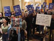 FILE - Protesters stand outside of the Senate chamber at the Indiana Statehouse on Feb. 22, 2023, in Indianapolis. The Human Rights Campaign declared a state of emergency for LGBTQ+ people in the U.S. on Tuesday, June 6 and a released a guidebook summarizing what it calls discriminatory laws in each state, along with "know your rights" information and health and safety resources.