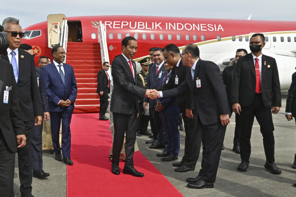 In this photo released by Malaysia's Department of Information, Indonesian president Joko Widodo, center, is greeted by representatives from Malaysian government upon the arrival at KLIA international airport in Sepang, Malaysia Wednesday, June 7, 2023.