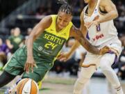 Seattle Storm guard Jewell Loyd (24) drives, drawing a foul from Phoenix Mercury guard Moriah Jefferson (8), during a WNBA basketball game Saturday, June 24, 2023, at Climate Pledge Arena in Seattle.