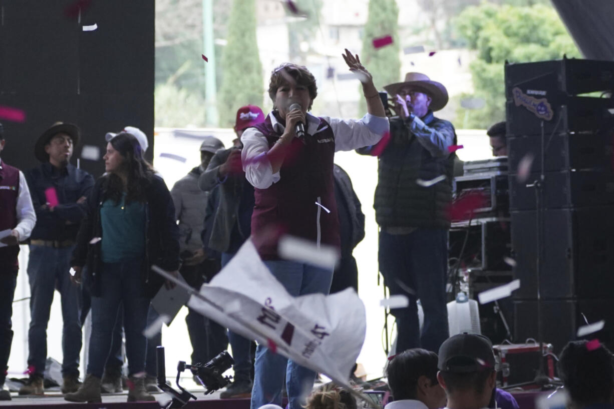 Delfina Gomez, left, MORENA political party gubernatorial candidate, speaks to the crowd during a campaign rally in Valle de Chalco, Mexico, Sunday, May 28, 2023. Voters in the state of Mexico go to the polls on June 4 to elect a new governor.