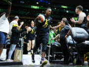 Seattle Storm guard Jewell Loyd runs out for warm ups wearing a Sue Bird shirt before a WNBA basketball game against the Washington Mystics, Sunday, June 11, 2023, in Seattle. Bird's jersey number was retired in a postgame ceremony.