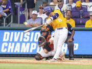 LSU's Hatden Travinski (25) swings for a home run against Oregon State during an NCAA college baseball tournament regional championship game in Baton Rouge, La., Monday, June 5, 2023.