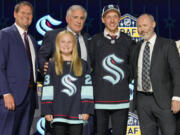 Eduard Sale, second from right, poses with Seattle Kraken officials after being picked 20th overall by the team during the first round of the NHL draft on Wednesday at Nashville, Tenn.