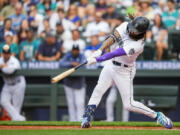 Seattle Mariners' J.P. Crawford hits a solo home run against Washington Nationals starting pitcher Trevor Williams during the first inning of a baseball game Monday, June 26, 2023, in Seattle.