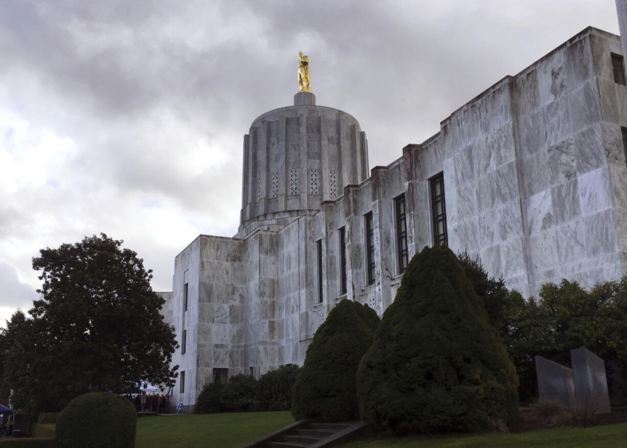 FILE - Clouds hover over the Oregon Capitol, Jan. 11, 2018, in Salem, Ore. Oregon Senate Democrats plan to start fining their absent colleagues amid a month-long Republican walkout, a move they hope will pressure boycotting lawmakers to return to the chamber as hundreds of bills languish amid the partisan stalemate. In a procedural move Thursday, June 1, 2023, Democrats voted to fine senators $325 every time their absence denies the chamber the two-thirds quorum it needs to conduct business.