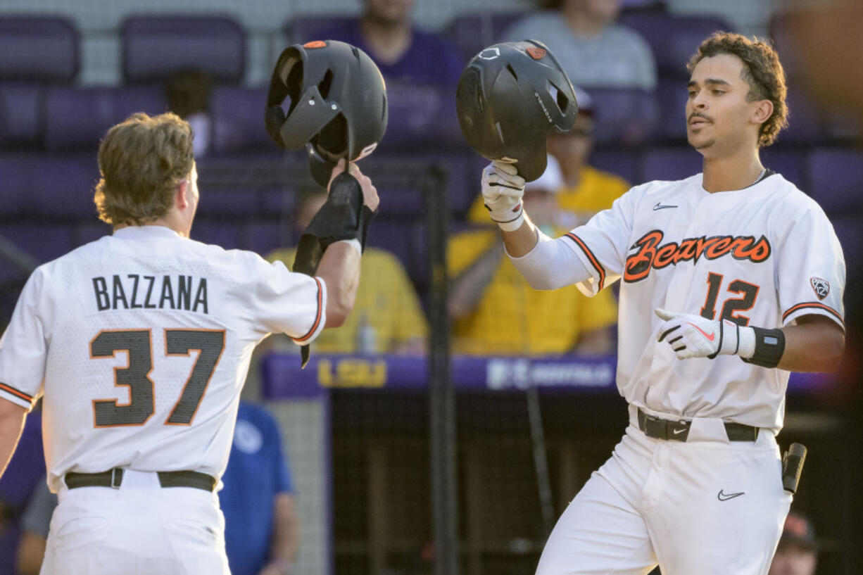 Oregon State outfielder Micah McDowell (12) celebrates a home run with Oregon State infielder Travis Bazzana (37) during an NCAA baseball game against Sam Houston on Friday, June 2, 2023, in Baton Rouge, La.