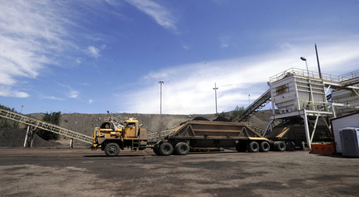 FILE - A truck takes on a load of phosphate ore at a hopper near Monsanto Company's South Rasmussen Mine Operation on July 16, 2009 near Soda Springs, Idaho. U.S. District Judge B. Lynn Winmill' has yanked approval for a phosphate mining project in southeastern Idaho, saying federal land managers in the Trump administration didn't in part properly consider the mine's impact on sage grouse. The judge's Friday, June 2, 2023, decision came five months after he found fault with the way the U.S. Bureau of Land Management approved the Caldwell Canyon Mine.