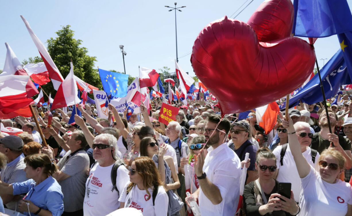 Participants join an anti-government march led by the centrist opposition party leader Donald Tusk, who along with other critics accuses the government of eroding democracy, in Warsaw, Poland, Sunday, June 4, 2023. Poland's largest opposition party led a march Sunday meant to mobilize voters against the right-wing government, which it accuses of eroding democracy and following Hungary and Turkey down the path to autocracy. The march is being held on the 34th anniversary of the first partly free elections, a democratic breakthrough in the toppling of communism across Eastern Europe.