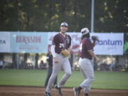 Ridgefield Raptors outfielder Tristan Gomes, left, is greeted by outfielder Jake Tsukada after Gomes made a leaping catch in left field to end the third inning against the Portland Pickles at Walker Stadium in Portland on Wednesday, June 14, 2023.