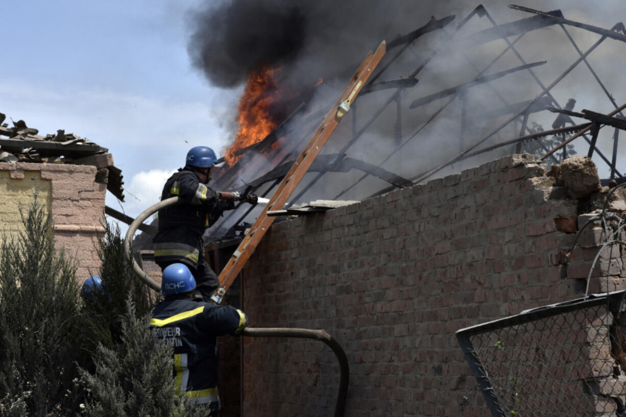 Ukrainian State Emergency Service firefighters put out fire after a Russian air raid hit a building in the village Preobrazhenka, Zaporizhzhya region, Ukraine, Wednesday, June 21, 2023.