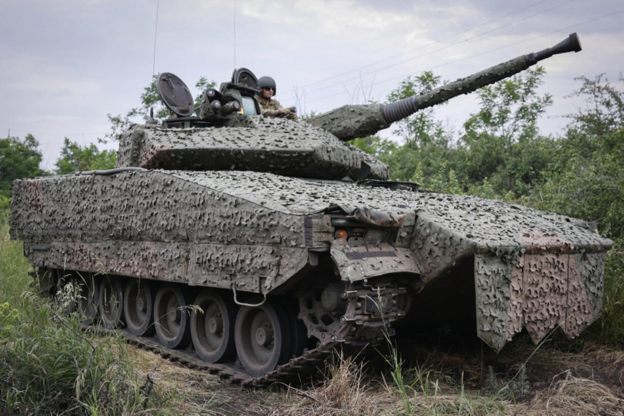 A Ukrainian soldier on a Swedish CV90 infantry fighting vehicle at his positions near Bakhmut, Donetsk region, Ukraine, Sunday, June 25, 2023.