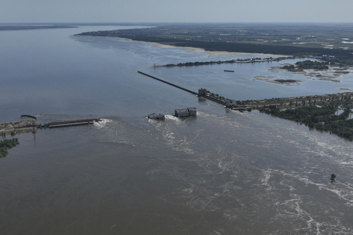Water flows over the collapsed Kakhovka Dam in Nova Kakhovka, in Russian-occupied Ukraine, Wednesday, June 7, 2023. Russia had the means, motive and opportunity to bring down a Ukrainian dam that collapsed earlier this month while under Russian control, according to exclusive drone photos and information obtained by The Associated Press.