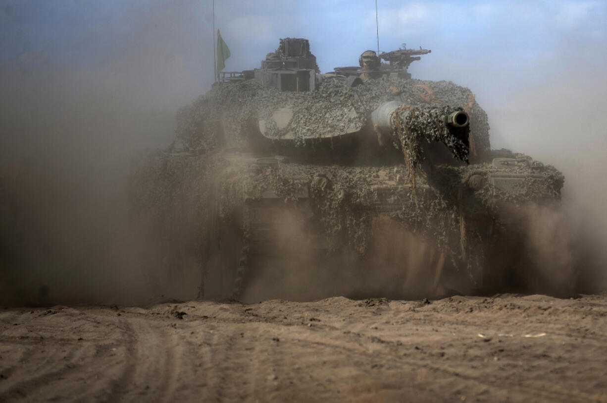 FILE - A German army Main battle tank Leopard 2A6 maneuvers during a visit by German President Frank-Walter Steinmeier to the Training Range in Pabrade, north of the capital Vilnius, Lithuania, May 30, 2023. Russia claimed it had "annihilated" eight tanks that NATO countries provided to Ukraine. But a visual analysis by The Associated Press shows a grainy black-and-white video Russia released prove it had blown up the German-made Leopard tanks actually documented the destruction of a tractor.