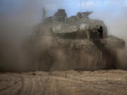 FILE - A German army Main battle tank Leopard 2A6 maneuvers during a visit by German President Frank-Walter Steinmeier to the Training Range in Pabrade, north of the capital Vilnius, Lithuania, May 30, 2023. Russia claimed it had "annihilated" eight tanks that NATO countries provided to Ukraine. But a visual analysis by The Associated Press shows a grainy black-and-white video Russia released prove it had blown up the German-made Leopard tanks actually documented the destruction of a tractor.