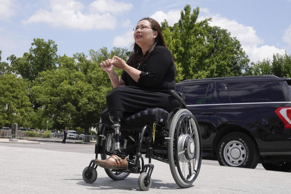 Sen. Tammy Duckworth, D-Ill., speaks with visitors Tuesday, June 13, 2023, on Capitol Hill in Washington.