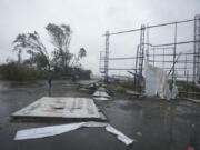 A big hoarding is seen on the ground following heavy winds and incessant rains after landfall of cyclone Biparjoy at Mandvi in Kutch district of Western Indian state of Gujarat, Friday, June 16, 2023. Cyclone Biparjoy knocked out power and threw shipping containers into the sea in western India on Friday before aiming its lashing winds and rain at part of Pakistan that suffered devastating floods last year.