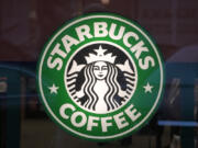 FILE - The Starbucks sign is displayed in the window of a Pittsburgh Starbucks, Jan. 30, 2023. On Monday, June 12, jurors in a federal court in New Jersey awarded $25.6 million to a former regional Starbucks manager who alleged that she and other white employees were unfairly punished by the coffee chain after the high-profile 2018 arrests of two Black men at one of the chain's Philadelphia locations. (AP Photo/Gene J.