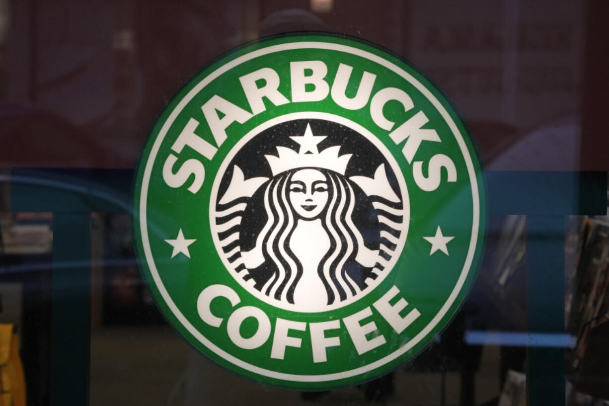 FILE - The Starbucks sign is displayed in the window of a Pittsburgh Starbucks, Jan. 30, 2023. On Monday, June 12, jurors in a federal court in New Jersey awarded $25.6 million to a former regional Starbucks manager who alleged that she and other white employees were unfairly punished by the coffee chain after the high-profile 2018 arrests of two Black men at one of the chain's Philadelphia locations. (AP Photo/Gene J.