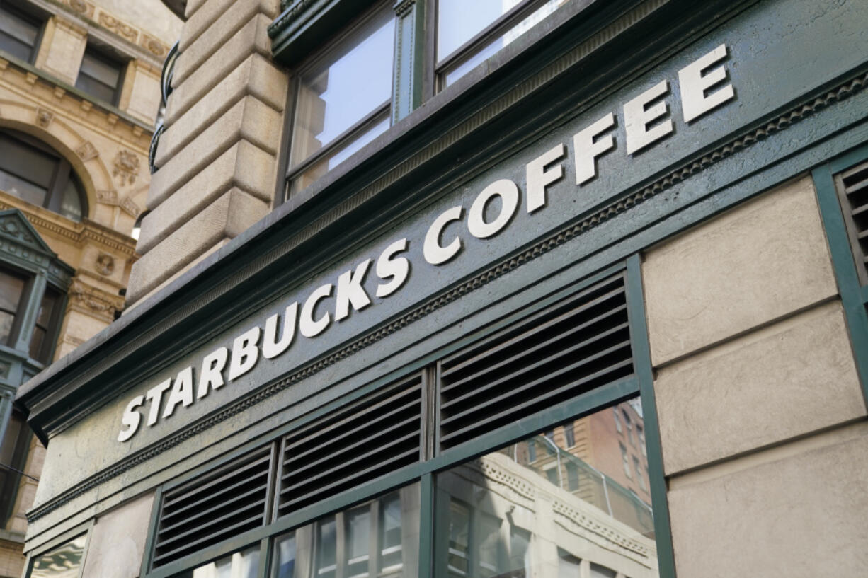 A Starbucks sign sits above a store in the Financial District of Lower Manhattan, Tuesday, June 13, 2023, in New York. Starbucks is denying union organizers' claims that it banned LGBTQ+ Pride displays in its U.S. stores after Target and other brands experienced backlash. The Seattle coffee giant says there has been no change to its policy and it encourages store leaders to celebrate Pride in June.