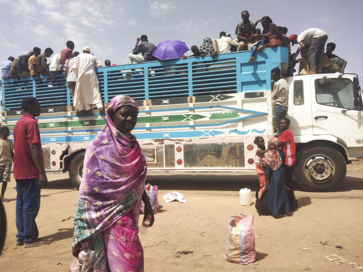 People board a truck as they leave Khartoum, Sudan, Monday, June 19, 2023. Sudan's warring parties have begun another attempt at a cease-fire after more than two months of brutal fighting -- and ahead of an international conference to raise funds for humanitarian assistance.