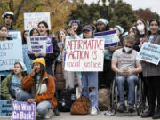 FILE - Activists demonstrate as the Supreme Court hears oral arguments on a pair of cases that could decide the future of affirmative action in college admissions, in Washington, Oct. 31, 2022. (AP Photo/J.