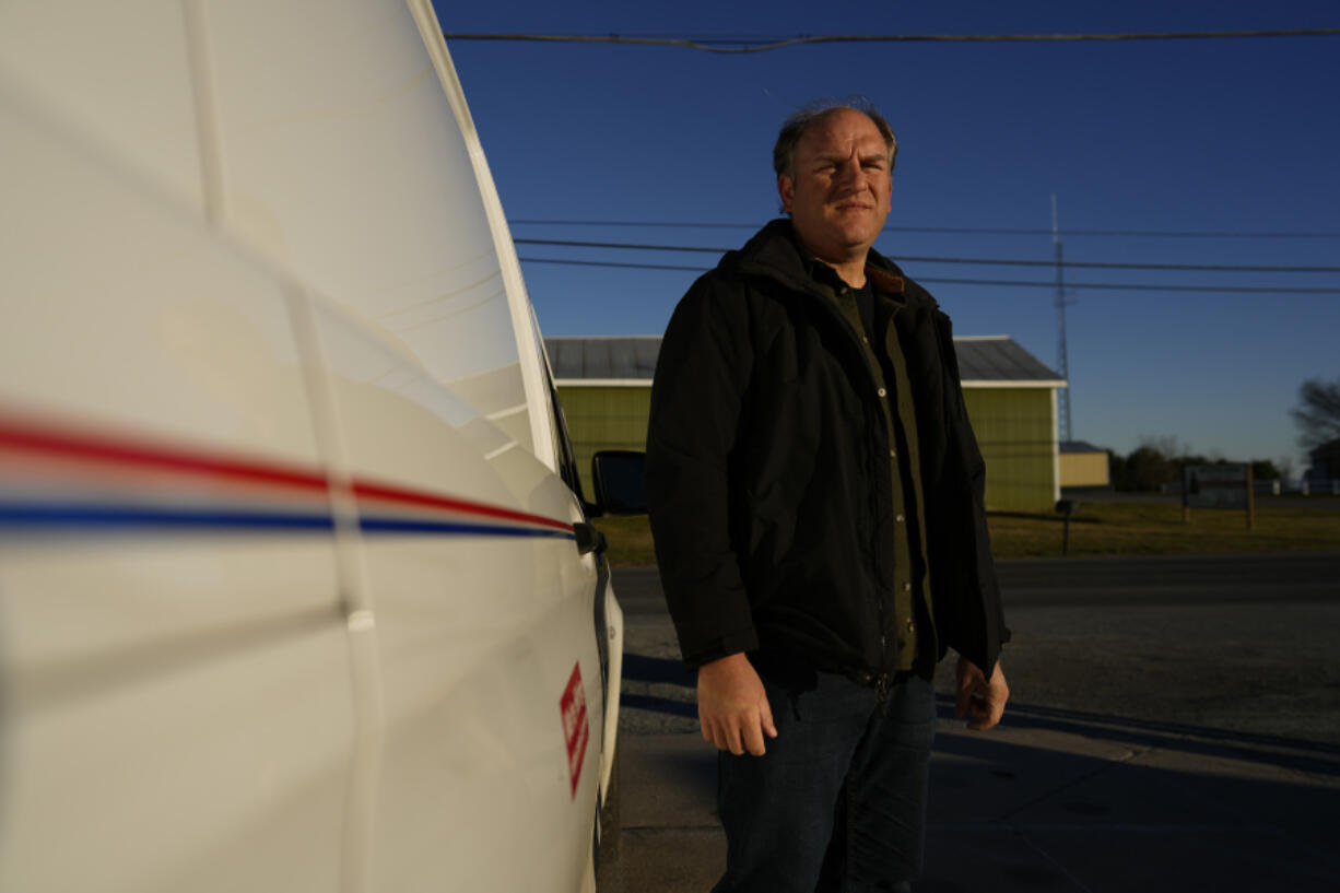 FILE - Gerald Groff, a former postal worker whose case will be argued before the Supreme Court, stands near a mail van outside the United States Post Office in Holtwood, Pa., Wednesday, March 8, 2023. The Supreme Court on Thursday, June 29, used the case of a Christian mailman who didn't want to work Sundays to solidify protections for workers who are religious. In a unanimous decision the justices made clear that workers who ask for religious accommodations, such as taking the Sabbath off, should get them unless their employers show doing so would result in "substantial increased costs" to the business.