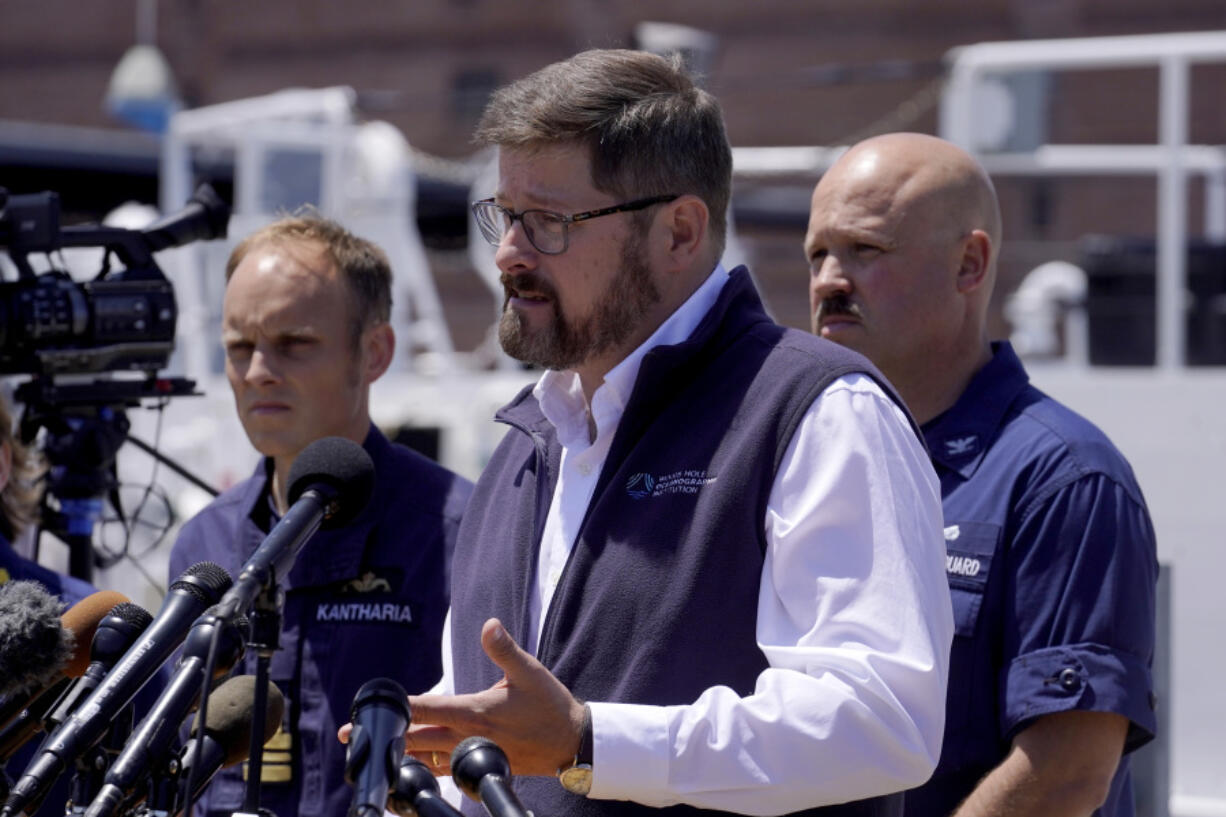 Carl Hartsfield, director and senior program manager Oceanographic Systems Laboratory, center, faces reporters as Royal Navy Lt Cdr Rich Kantharia, left, and U.S. Coast Guard Capt. Jamie Frederick, right, look on during a news conference, Wednesday, June 21, 2023, at Coast Guard Base Boston, in Boston. A Canadian surveillance vessel has detected more underwater noises in the area where rescuers are searching for a submersible that went missing in the North Atlantic while bringing five people down to the wreck of the Titanic, authorities said Wednesday.